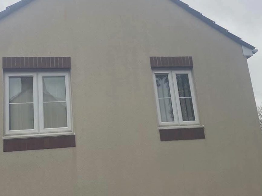 The same house after render cleaning — even, clean render The same house after render cleaning — even, clean render